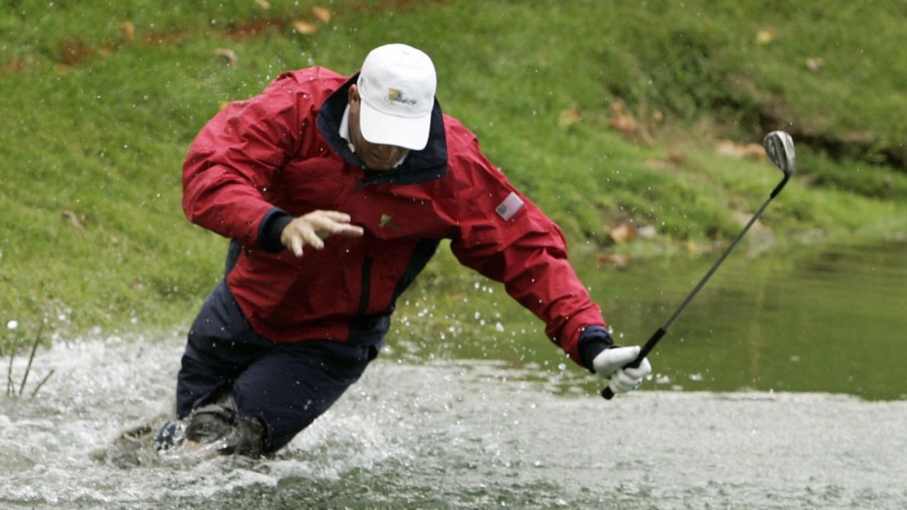 Woody Austin falls in the pond next to the 14th green after playing a shot at the 2007 Presidents Cup at Royal Montreal Golf Club